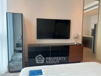 Modern bedroom with sleek TV setup and stylish decor