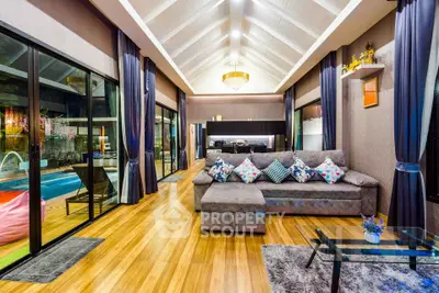 Luxurious living room with pool view, high ceilings, and elegant decor