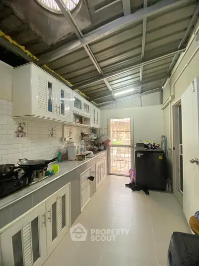 Spacious kitchen with modern cabinetry and ample natural light