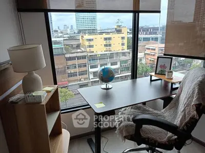 Modern study room with city view, featuring a desk, chair, and globe, ideal for work-from-home setup.