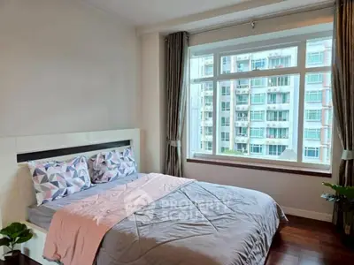 Bright and cozy bedroom with large window and modern decor