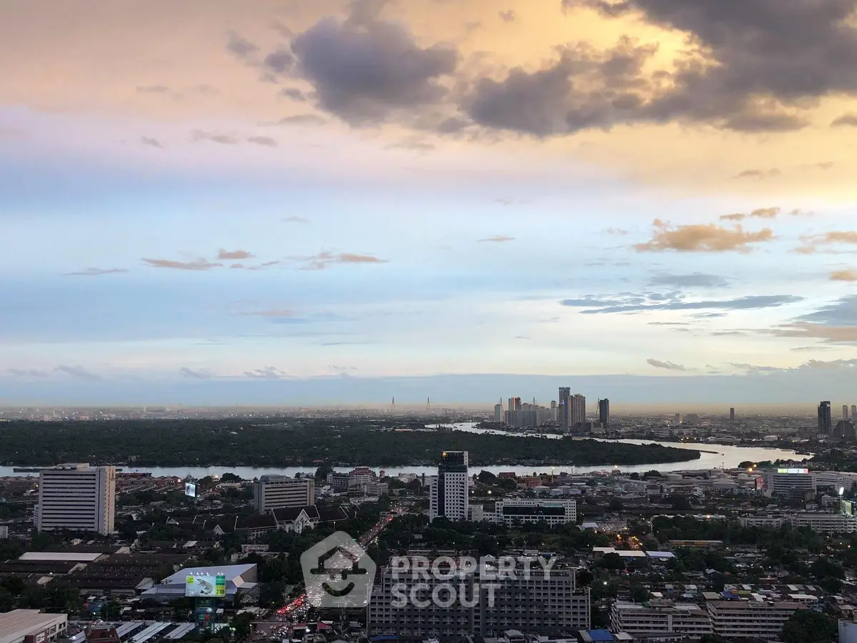 Stunning cityscape view with river and skyline at sunset, perfect for urban living enthusiasts.