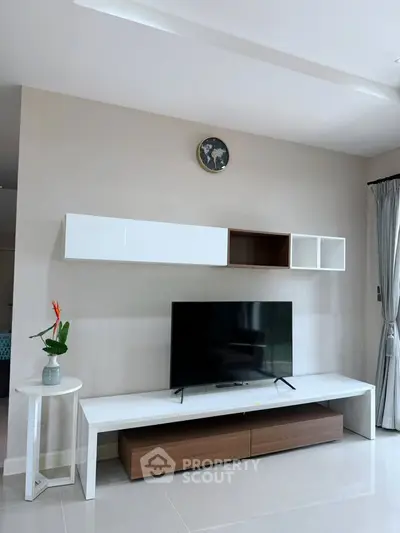 Modern living room with sleek TV unit and stylish wall shelves, perfect for contemporary living.