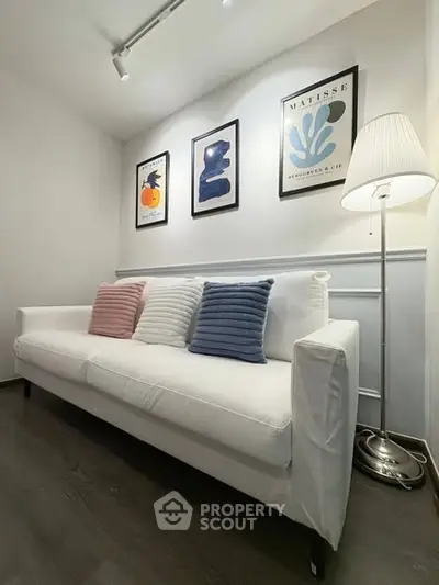 Stylish living room with modern art and cozy white sofa