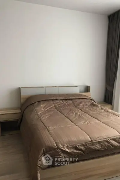 Cozy bedroom with modern wooden furniture and elegant curtains, perfect for relaxation.