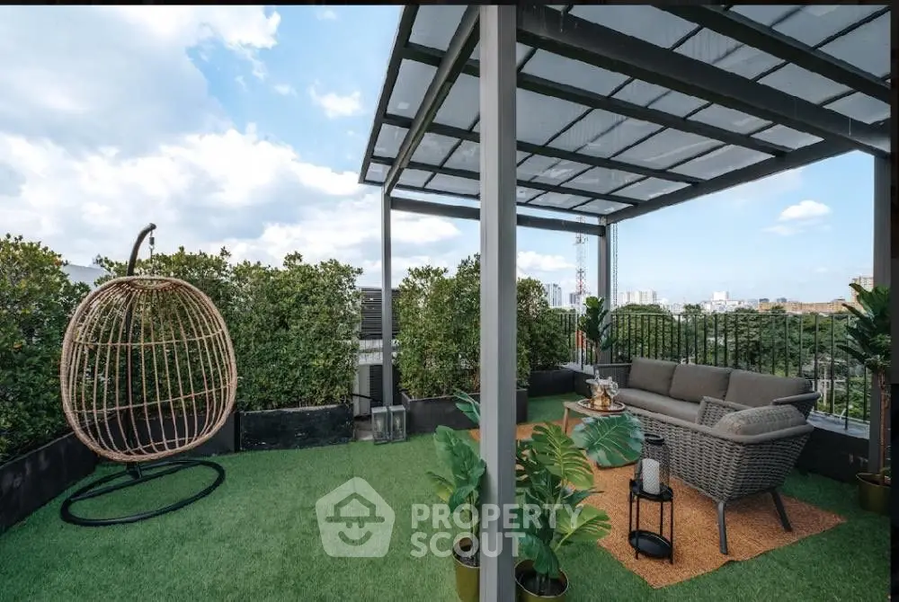 Stunning rooftop terrace with modern seating and lush greenery, perfect for relaxation and entertainment.