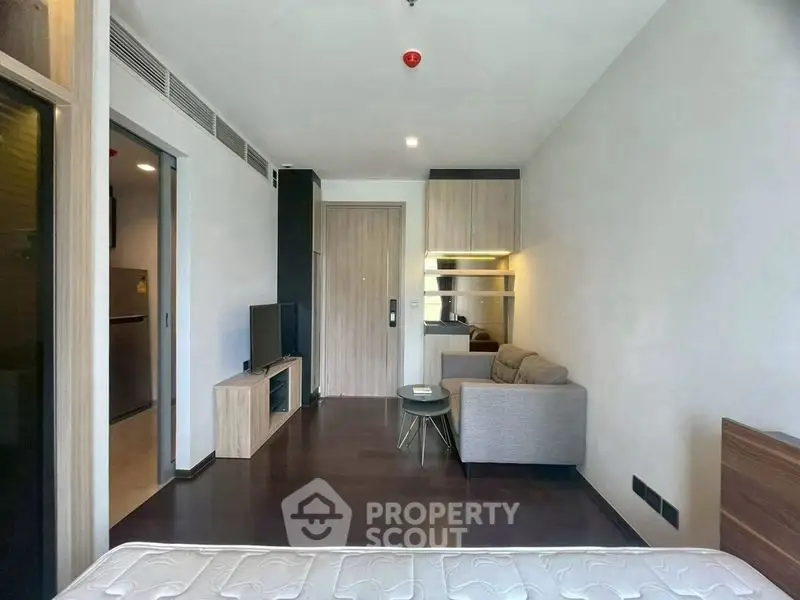 Modern studio apartment with sleek interior design and cozy living area.