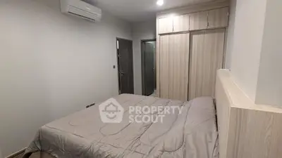 Modern bedroom with sleek design, featuring built-in wardrobe and air conditioning for ultimate comfort.