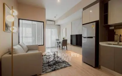 Modern living room with open kitchen, stylish decor, and natural light in a cozy apartment.