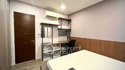 Modern bedroom with study area, featuring sleek furniture and ambient lighting.