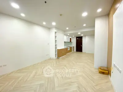 Spacious modern living room with open kitchen and elegant wooden flooring