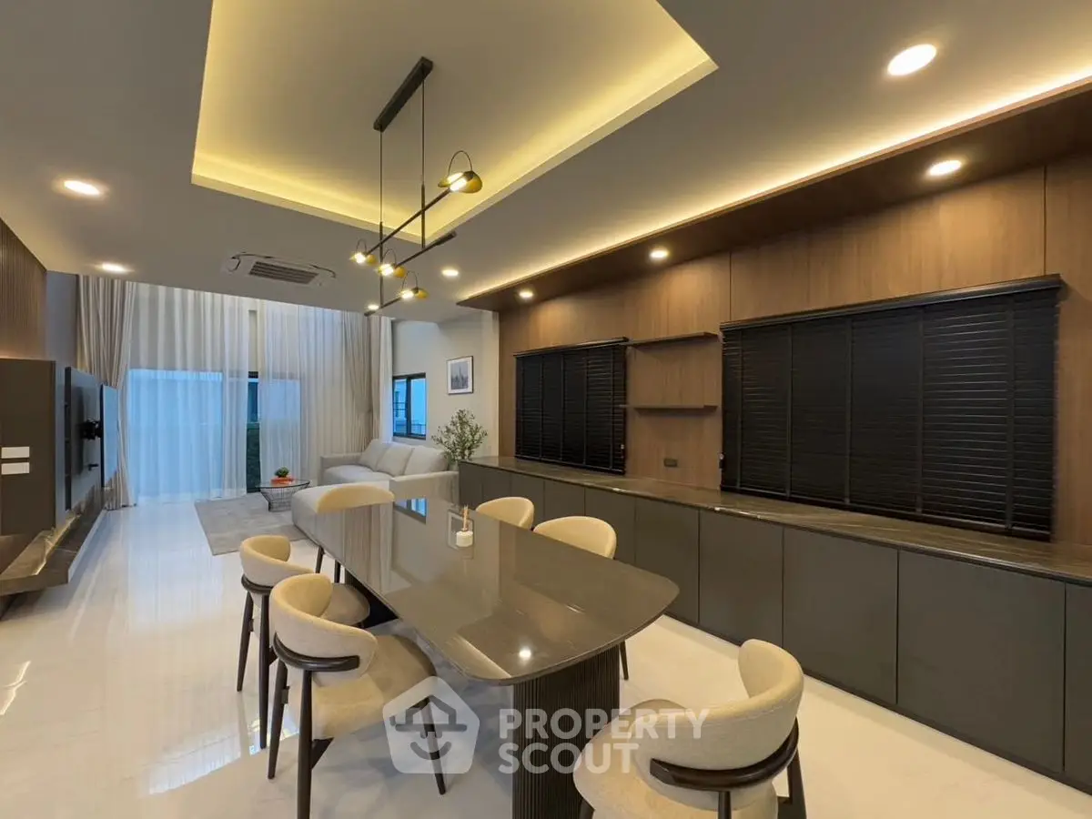 Luxurious modern dining area with sleek table, elegant lighting, and stylish decor.