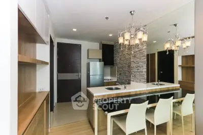 Modern kitchen with elegant chandelier and sleek design