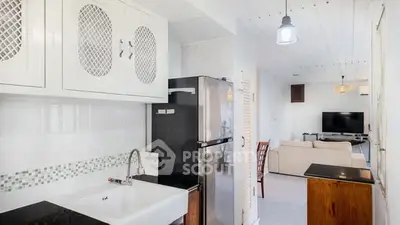 Charming open-layout kitchen with modern appliances and cozy living room view.