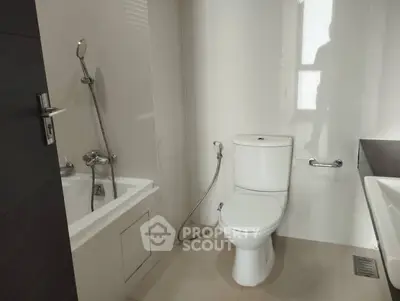 Modern bathroom with sleek fixtures and a bathtub, ideal for contemporary living.