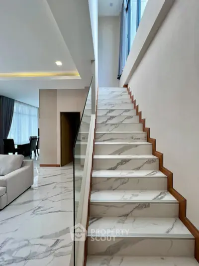 Luxurious modern interior with marble staircase and spacious living area