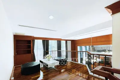 Elegant living room with wooden floors and modern furniture in a spacious home.