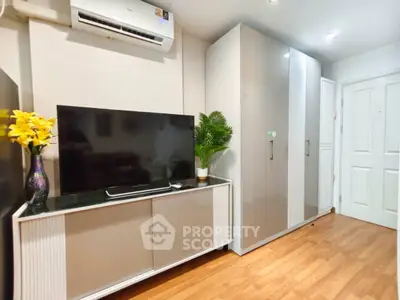 Modern living room with sleek TV stand, air conditioning, and stylish wardrobe.
