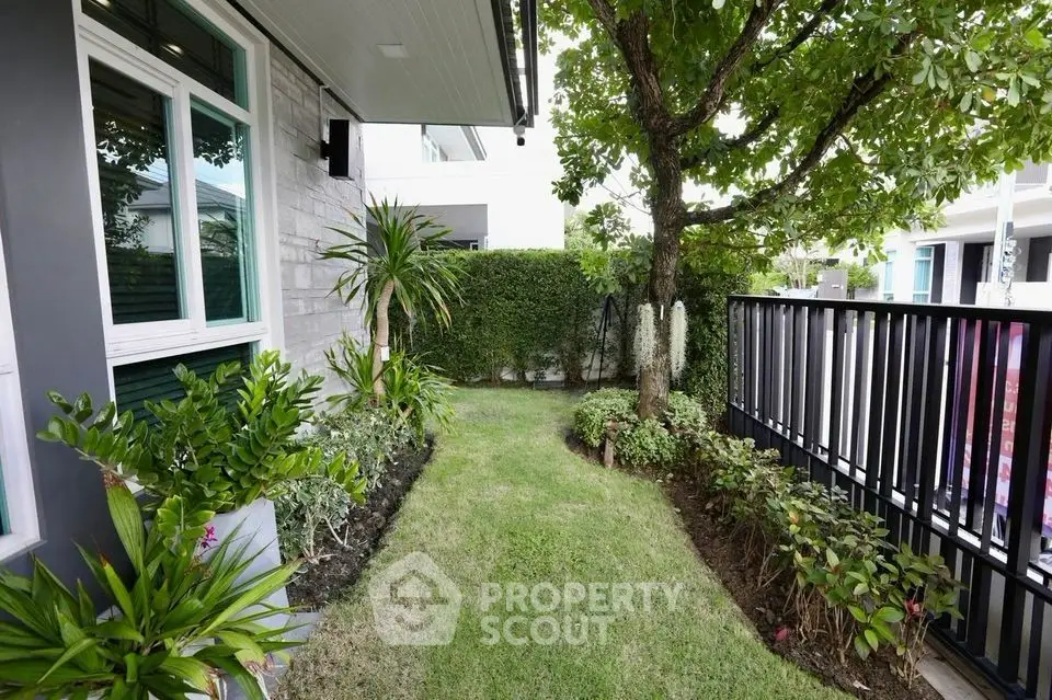 Charming garden view with lush greenery and modern fencing in a serene residential area.