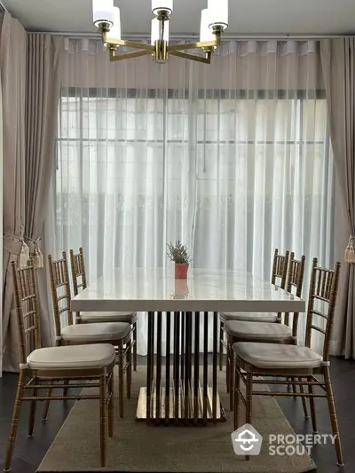 Elegant dining room with modern chandelier and stylish table setting