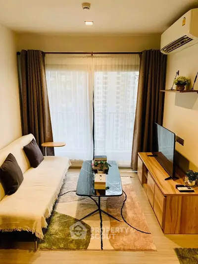 Modern living room with stylish decor, large window, and cozy seating area in a contemporary apartment.