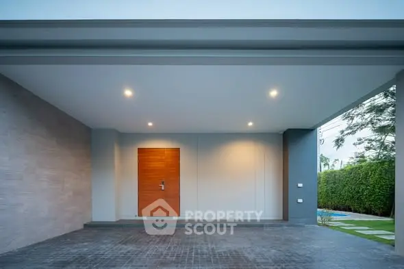Modern house entrance with sleek design and spacious driveway