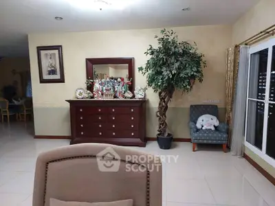 Spacious living room with elegant decor and large indoor plant