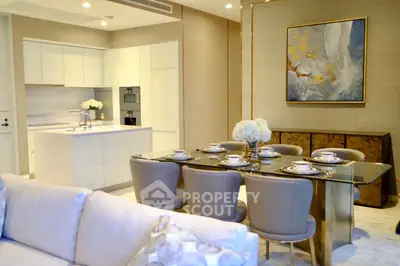 Luxurious open-plan living and dining area with elegant decor and modern kitchen.