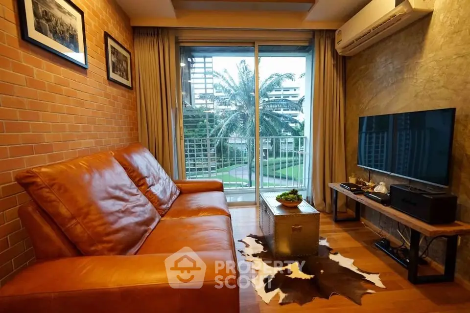 Stylish living room with leather sofa and balcony view in modern apartment