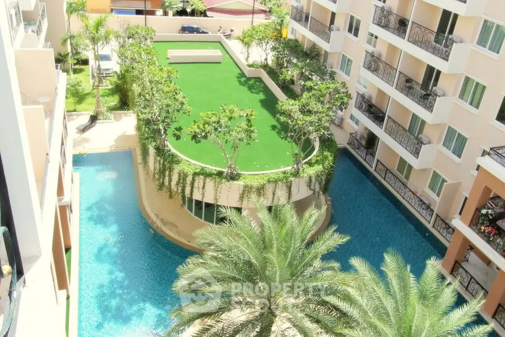 Luxurious apartment complex with pool and lush garden view