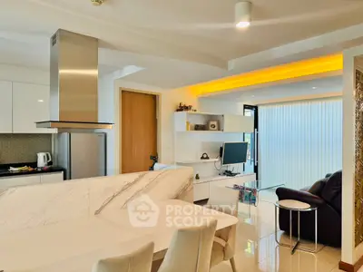 Modern open-plan kitchen and living room with sleek marble countertops and contemporary furnishings.