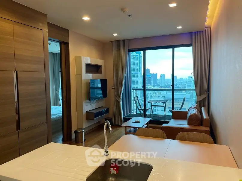 Modern apartment with open kitchen and city view balcony, featuring sleek wooden finishes and cozy living area.