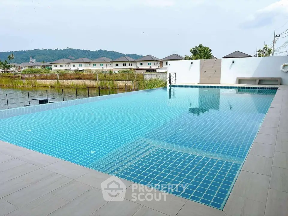 Luxurious infinity pool with scenic mountain and residential view