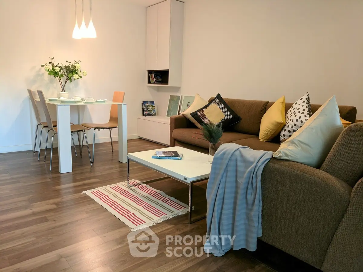 Stylish modern living room with cozy seating and elegant dining area, perfect for relaxation and entertaining.