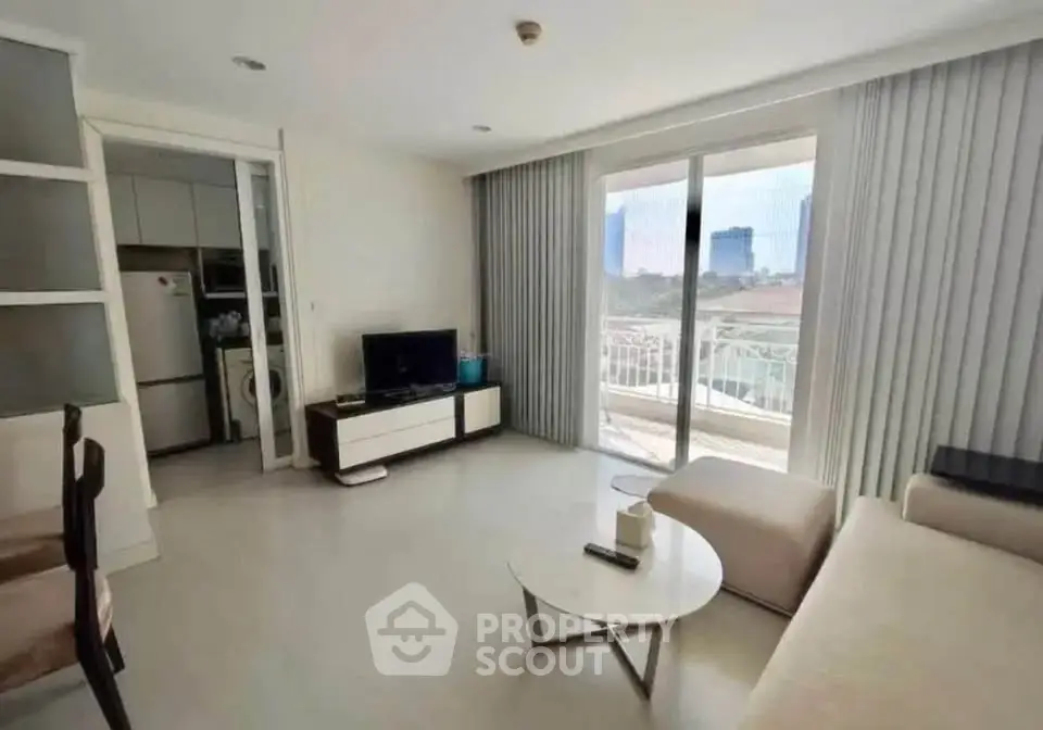 Bright living room with modern furniture and balcony view in a stylish apartment.