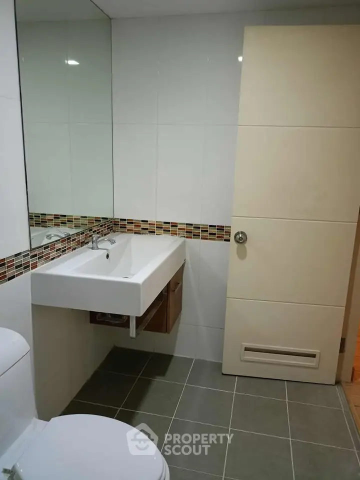 Modern bathroom with sleek sink and stylish tile accents