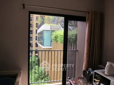 Modern apartment balcony with lush green view and cityscape