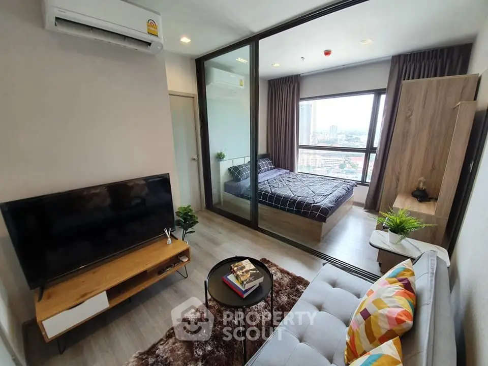 Modern condo interior with cozy living room and bedroom, featuring stylish decor and city view.