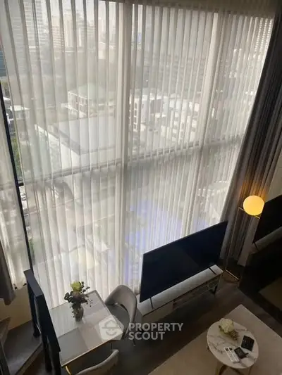 Stunning high-rise apartment with floor-to-ceiling windows offering breathtaking city views and modern interior design.
