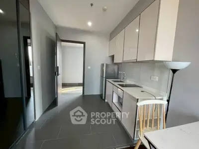 Modern kitchen with sleek cabinetry and integrated appliances in a stylish apartment.