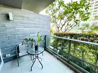 Charming balcony with lush greenery and modern glass railing in urban setting