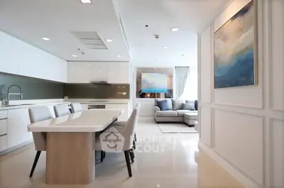 Elegant open-plan kitchen and living room with modern decor and natural light.