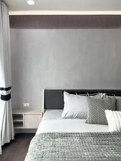 Modern bedroom with stylish decor and cozy bedding