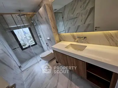 Luxurious modern bathroom with marble tiles and city view