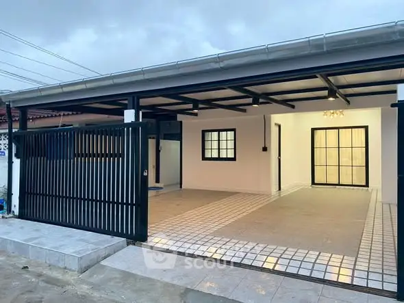 Modern single-story home with spacious tiled carport and sleek black gate.