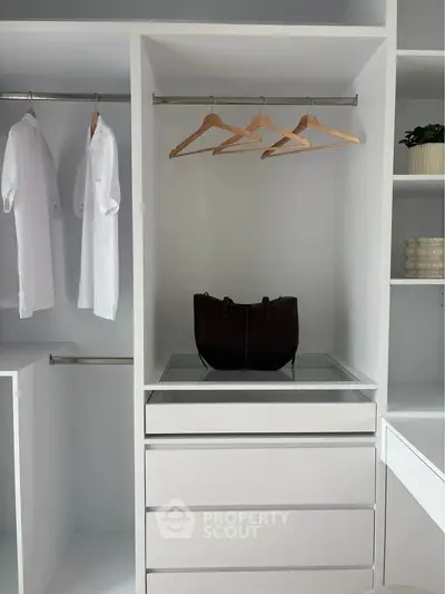 Spacious walk-in closet with modern design and ample storage space.