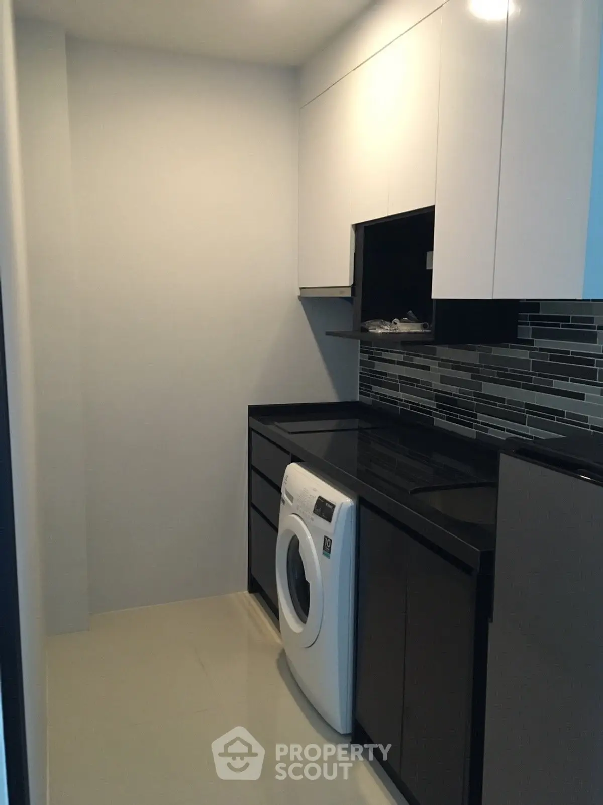 Modern kitchen with sleek cabinets and built-in washing machine