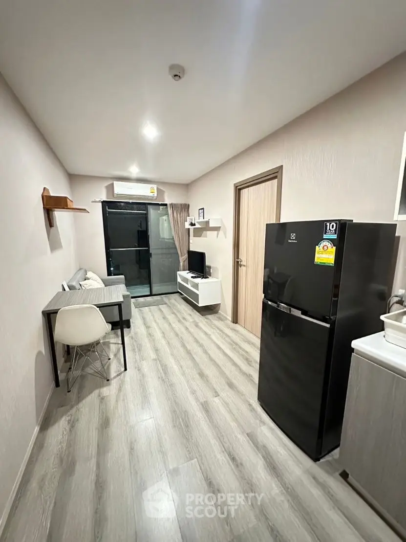 Modern apartment interior with sleek design and open layout, featuring a stylish kitchen and cozy living area.
