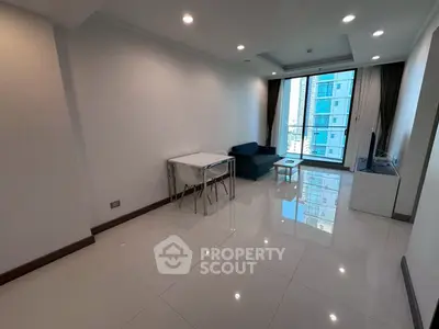 Modern living room with sleek furniture and large window offering city view