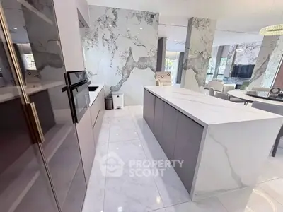 Luxurious modern kitchen with sleek marble countertops and open layout design.